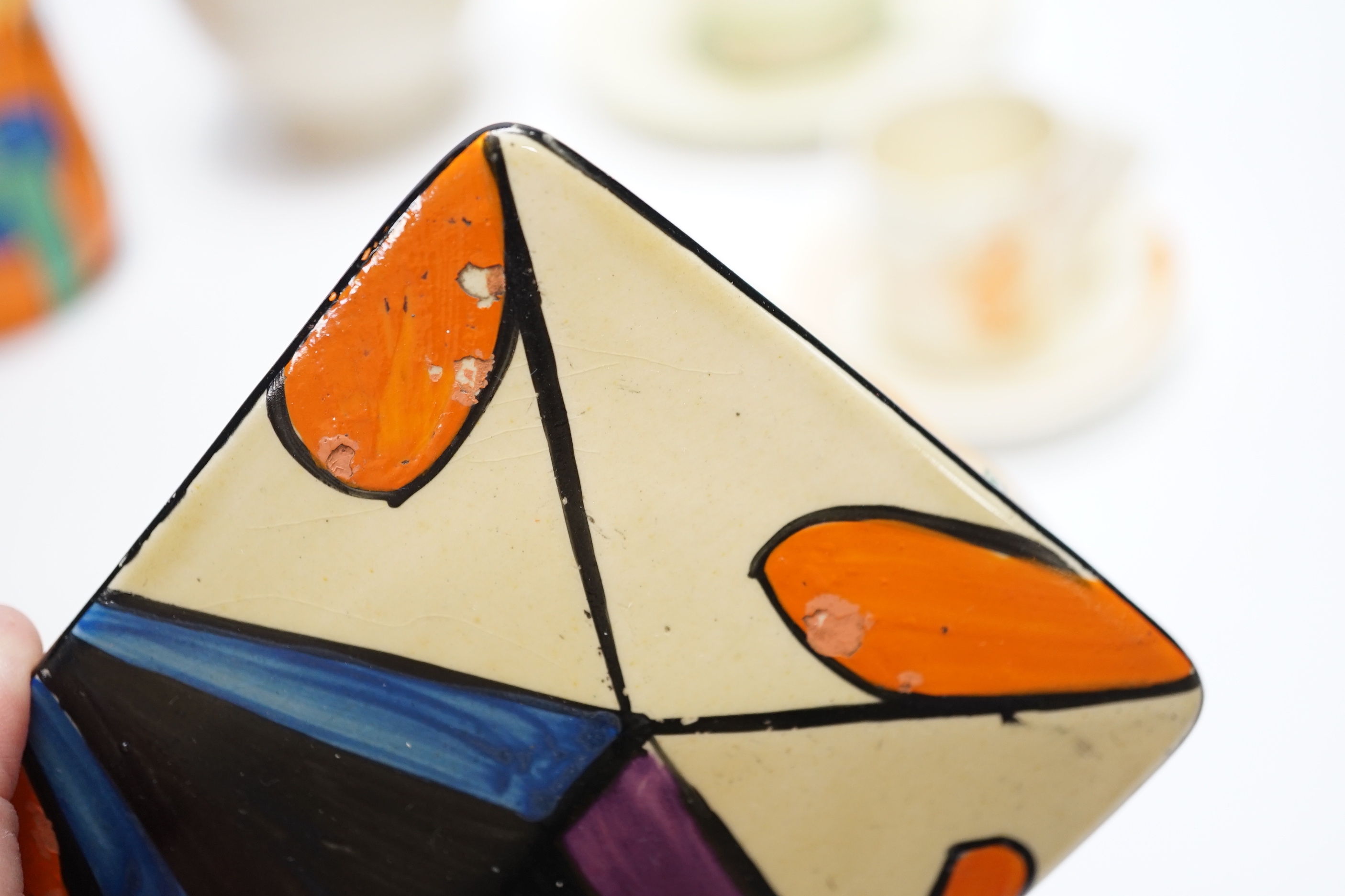 A Clarice Cliff Fantasque butter dish and cover, a Bizarre pot and five other Clarice Cliff items, tallest 20.5cm high